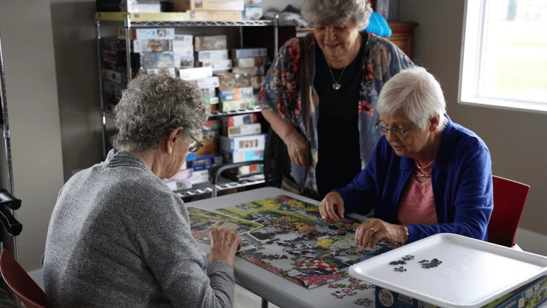 Three elderly women solving the Jigsaw puzzle at Fleetwood residence