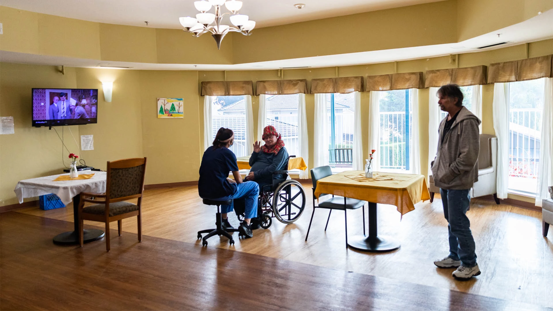 An elderly woman taking with health care worker