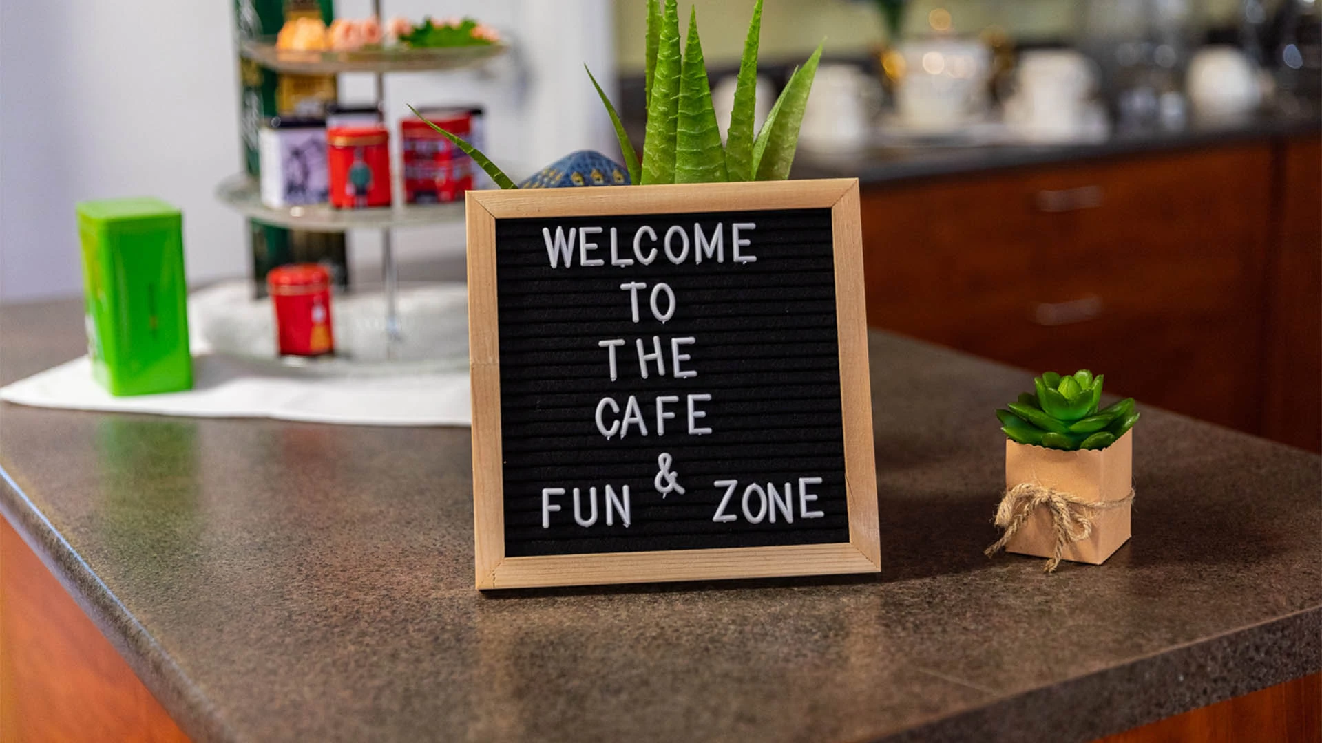 A cafe and a fun zone welcoming board